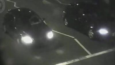 Two cars, captured at night on CCTV