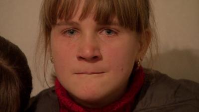 A crying girl in an underground shelter in Donetsk