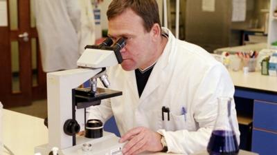 Student looking through microscope in laboratory classroom at John Moores University, Liverpool, 2001