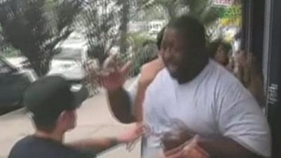 Still from video posted online of Eric Garner being confronted by police officers