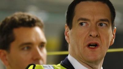 George Osborne (right) looks at a car on the production line at Bentley Motors in Crewe