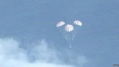 In this frame grab from NASA-TV, the Orion spacecraft descends before splashing down in the Pacific Ocean