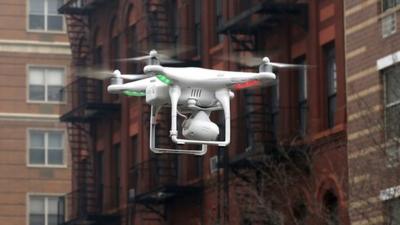 A drone flying down a street