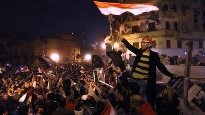 Egyptians celebrate in Tahrir Square after hearing the news of the resignation of Egyptian President Hosni Mubarak on February 11, 2011 in Cairo, Egypt.