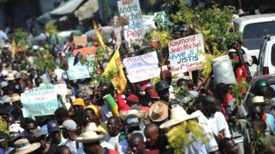 Demonstrators march during a protest against the government of President Michel Martelly in Port-au-Prince, on December 12, 2014