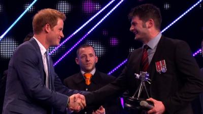 Prince Harry presents the Helen Rollason award to the competitors in the Invictus Games