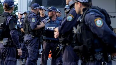 Police confer on Philip St near the Lindt Cafe, Martin Place on December 15, 2014 in Sydney, Australia