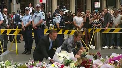 Tony Abbott lays flowers down