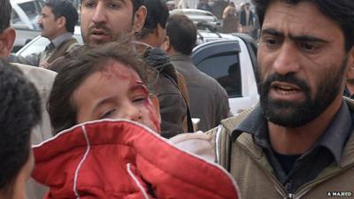 Man carrying small girl injured in Taliban attack on Pakistan school