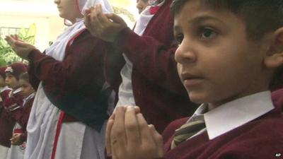 Close up of schoolboy in Pakistani city of Karachi saying prayers for victims of Peshawar school attack