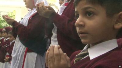 Close up of boy in Pakistani city of Karachi saying prayers for victims of Peshawar school attack