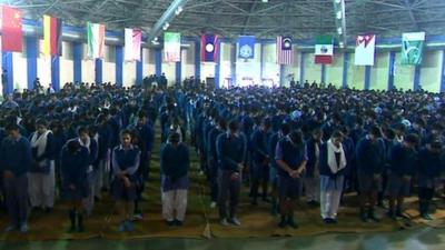 Students at a school in Delhi hold prayers to mark a deadly attack on a school in Pakistan