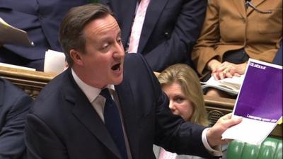 David Cameron waves Labour document at PMQs