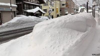 Head-high snowdrifts by roadside in Tsunan, Niigata Prefecture Japan