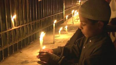 Boy lighting candles