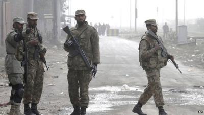 Pakistan army troops stand guard at a road leading to the central prison on the outskirts of Lahore