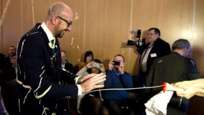 Female protestor squirts Belgian Prime Minister Charles Michel with mayonnaise