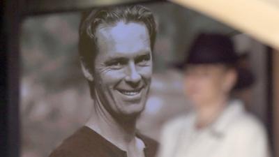 An image of Tori Johnson is projected onto the wall of a church during the funeral service in Sydney