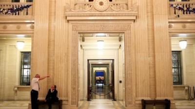 5People wait in the Great Hall at Parliament Buildings, Stormont, as political talks continue in Stormont House