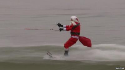 'Santa Claus' water skis at an event on the Potomac River in Old Town Alexandria, Virginia