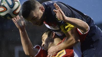 Crusaders Colin Coates in action against Cliftonville's David McDaid