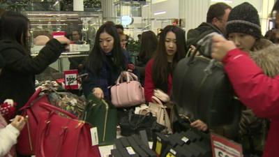 Shoppers looking at handbags