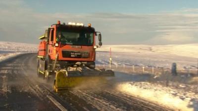 Snow plough clearing snow on road in Yorkshire Dales