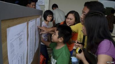 Relatives look at passenger list