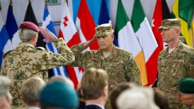 Commander ISAF, General John F. Campbell (centre) salutes Commander Joint Force Command Brunssum, General Hans-Lothar Domrose during the Change of Mission Ceremony in Kabul