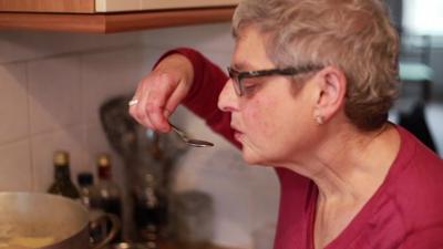 Debbie Epstein tasting soup from her mother's pan