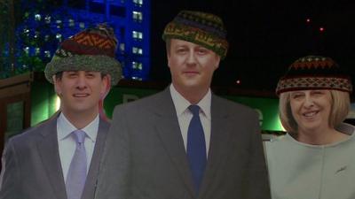 Cardboard statues of political leaders in hats