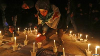 Activists light candles over pictures of war victims at a new year event in Salah al-Din, central Aleppo December 31 2014
