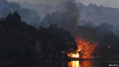 In a picture taken on January 3, 2015, a bushfire burns through scrub near Gumeracha in the Adelaide Hills