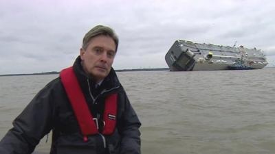 BBC reporter Duncan Kennedy reports from a dinghy near the stranded Hoegh Osaka car transporter