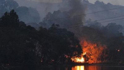 In a picture taken on January 3, 2015, a bushfire burns through scrub near Gumeracha in the Adelaide Hills