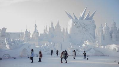 Visitors look at snow sculptures during the 16th Harbin International Ice and Snow Festival in Harbin, northeast China"s Heilongjiang province on January 5, 2015