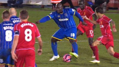 AFC Wimbledon striker Adebayo Akinfenwa aka 'The Beast' in action against Liverpool