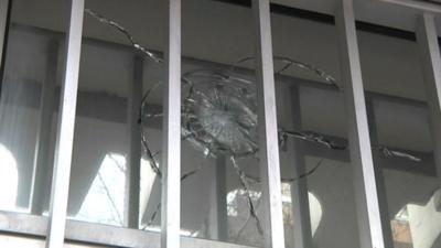 Glass with bullet hole