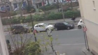 Person running from gunshots on street with parked cars