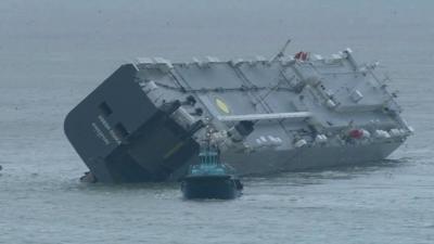 The Hoegh Osaka being towed to Portsmouth Harbour