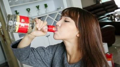 Chinese woman drinking baijiu