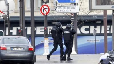 French intervention police are seen at the scene of a hostage taking at a kosher supermarket