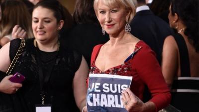 Dame Helen Mirren, right, holding banner reading "Je suis Charlie"