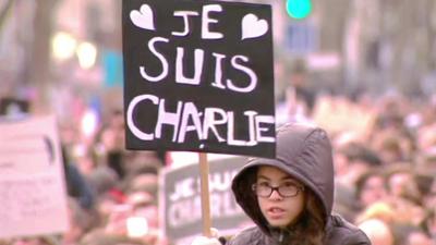 Protester in Paris holds a banner displaying "Je Suis Charlie" (I am Charlie)