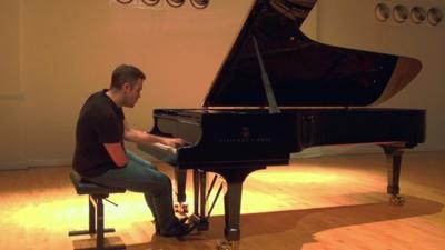 Nicholas McCarthy playing the piano