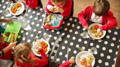 Pupils eating roast dinner