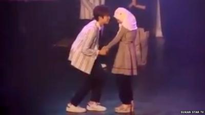 K-Pop star holds hand of young Muslim girl