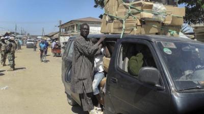 A photograph made available on 14 January 2015 shows Nigerians crammed into a bus fleeing the town of Mubi following recent attacks in north-east Nigeria, 9 December 2014