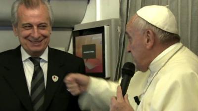 Pope Francis on the papal plane with his assistant
