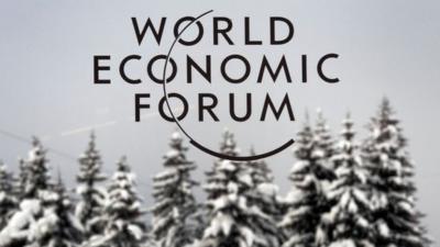 The logo of World Economic Forum (WEF) logo in front of snow-covered trees, file pic from 2012